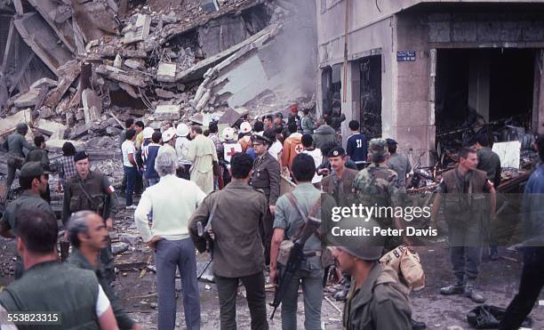 Crowd of soldiers and aid givers stand amid the destruction and damage at the scene of the suicide bombing of the American Embassy, Beirut, Lebanon,...