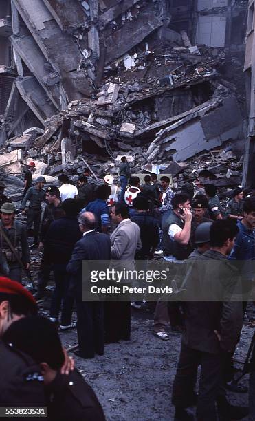 Crowd of soldiers and aid givers stand amid the destruction and damage at the scene of the suicide bombing of the American Embassy, Beirut, Lebanon,...