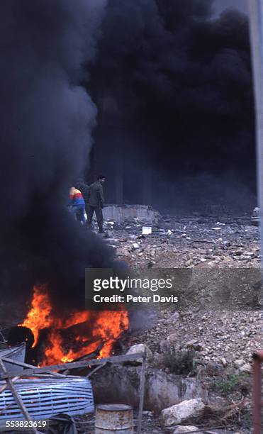 Burning fires produce dark smoke at the site of the suicide bombing of the American Embassy, Beirut, Lebanon, April 18, 1983.