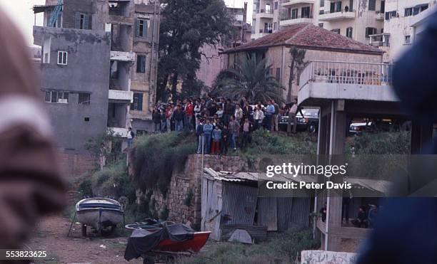 Crowd gathers to look at the destruction and damage at the scene of the suicide bombing of the American Embassy, Beirut, Lebanon, April 18, 1983.