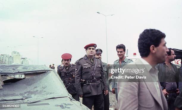 Crowd of soldiers and aid givers stand amid the destruction and damage at the scene of the suicide bombing of the American Embassy, Beirut, Lebanon,...