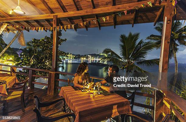honeymoon couple at restaurant at dusk. - mesa para dos fotografías e imágenes de stock