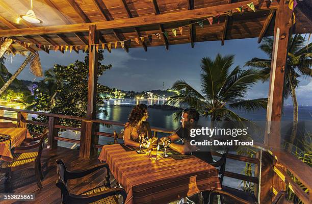 honeymoon couple at restaurant at dusk. - tee srilanka stock pictures, royalty-free photos & images