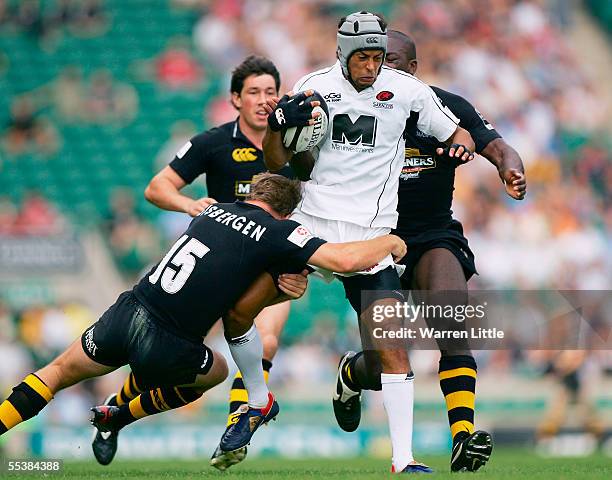 Richard Haughton of Saracens is stopped by Mark van Gisbergen of Wasps during the Guinness Premiership match between London Wasps and Saracens at...