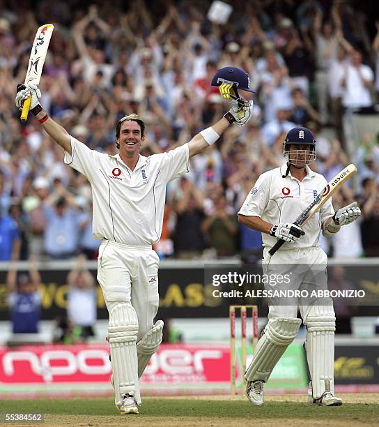 London, UNITED KINGDOM: England's Kevin Pietersen celebrates his first Test century as team-mate Ashley Giles applauds as he bats against Australia...