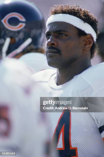 Walter Payton of the Chicago Bears looks on to the field during training camp at the University of Wisconsin on August of 1987 in Platteville,...