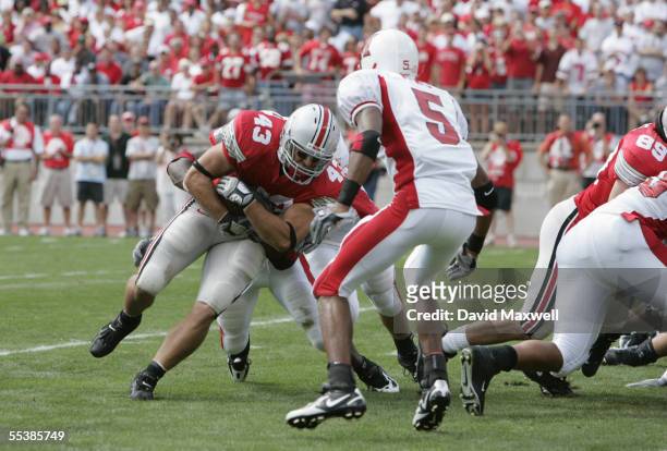 Fullback Brandon Schnittker of the Ohio State Buckeyes is tackled by a Miami Redhawks player on September 3, 2005 at Ohio Stadium in Columbus, Ohio....