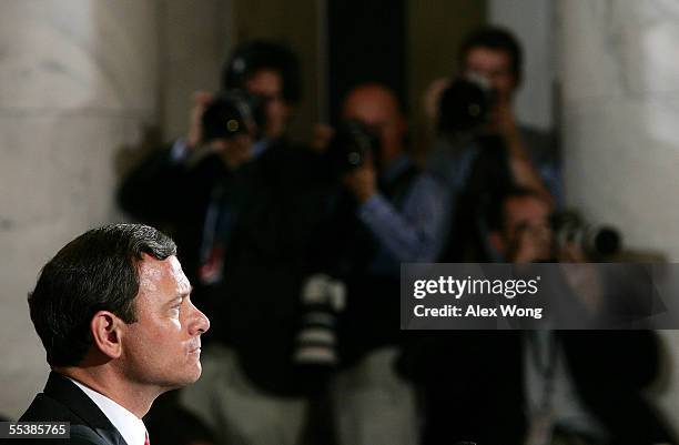 Supreme Court Chief Justice nominee John Roberts listens to opening statements by various Senators on his first day of confirmation hearings...