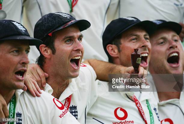 Michael Vaughan captain of England celebrates with a replica Ashes Urn as he joins team mates in song after England regained the Ashes during day...