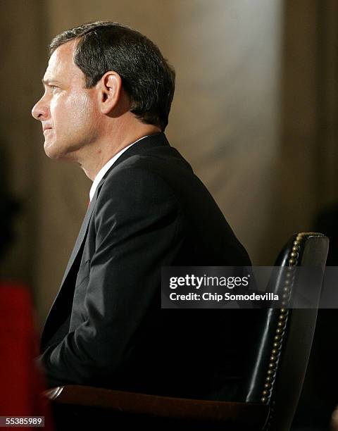 Supreme Court Chief Justice nominee John Roberts listens to opening statements by various Senators on his first day of confirmation hearings...