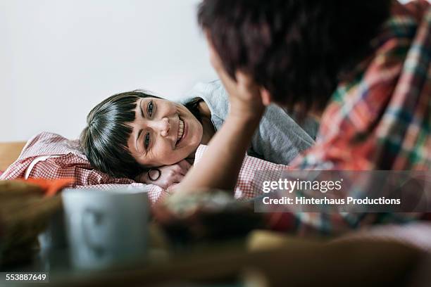 lesbian couple enjoying togetherness - lesbian bed stock pictures, royalty-free photos & images