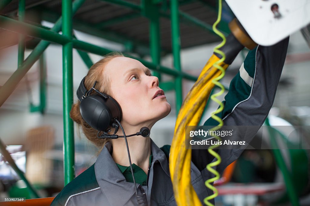 Engineer wearing ear protectors in hangar