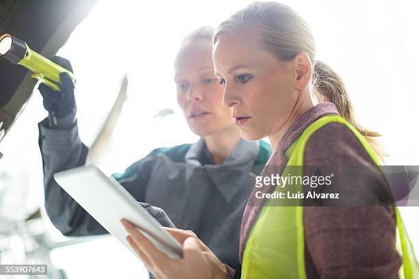 supervisor and engineer using tablet pc at hangar - aircraft maintenance stock pictures, royalty-free photos & images