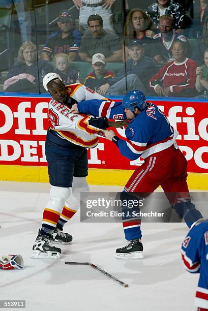 Peter Worrell of the Florida Panthers and Dale Purinton of the New York Rangers fight during the game at National Car Rental Center in Sunrise,...