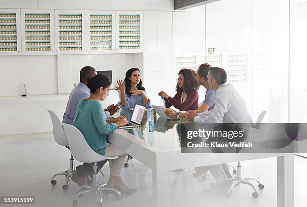 business people at meeting, by glass table - conference table top stock pictures, royalty-free photos & images