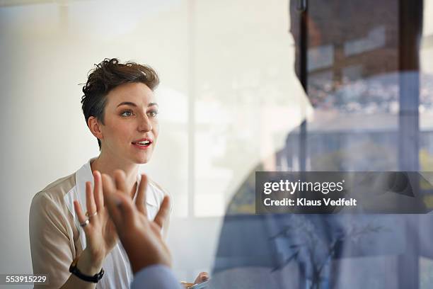 businesswoman having discussion with male coworker - conflict photos et images de collection