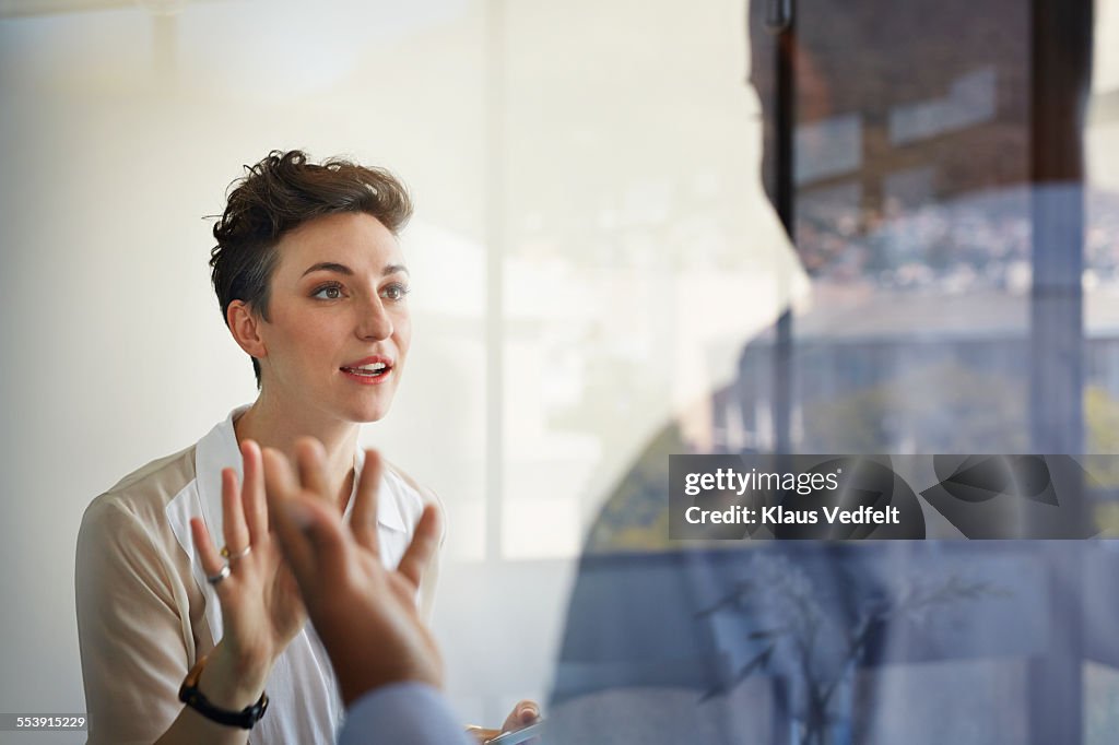 Businesswoman having discussion with male coworker