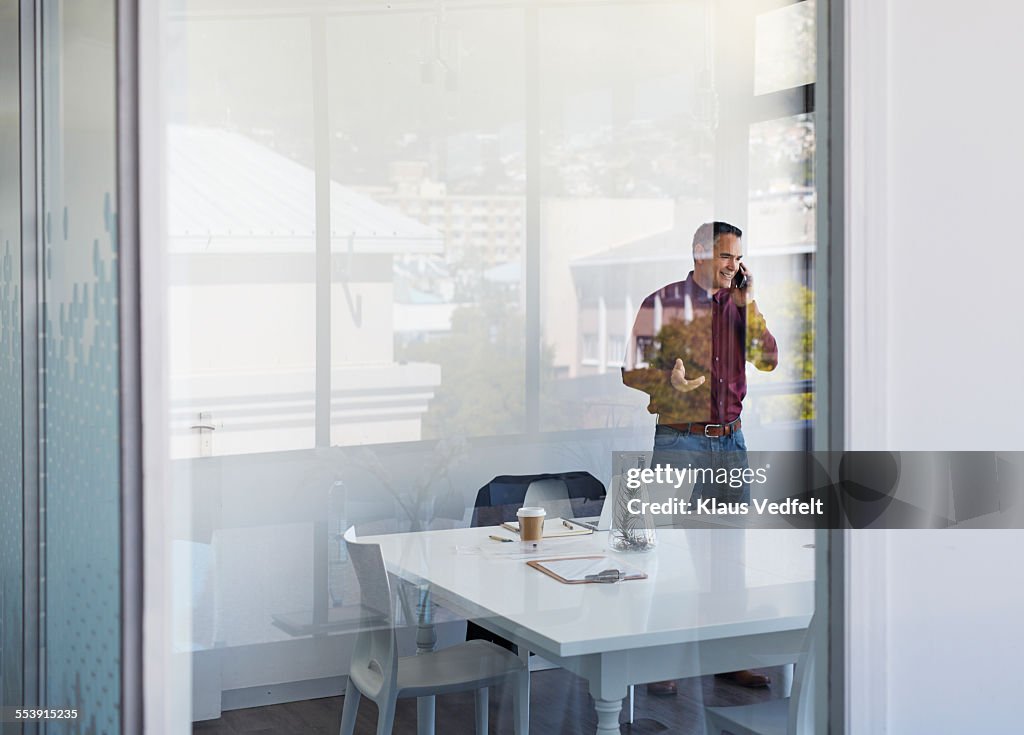 Businessman laughing while on the phone