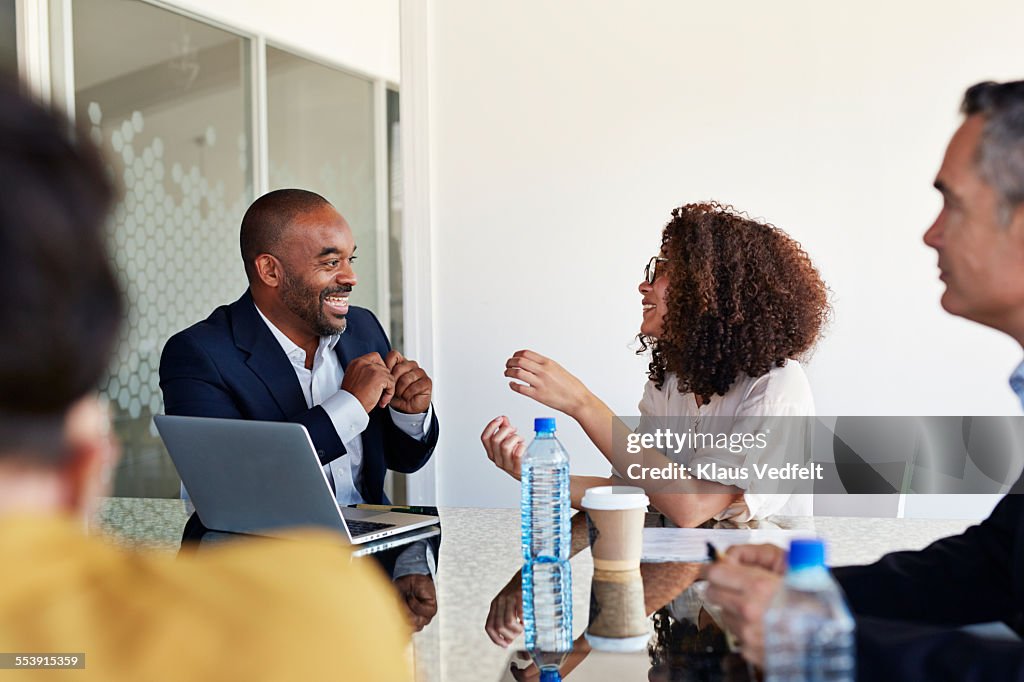 Businesspeople laughing at meeting