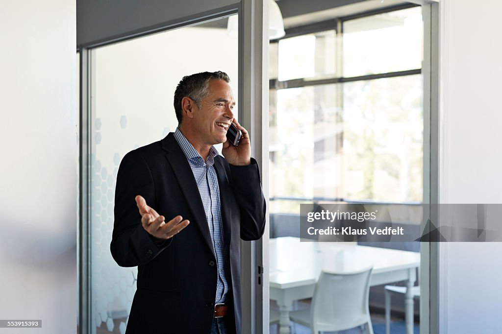 Businessman laughing while on the phone