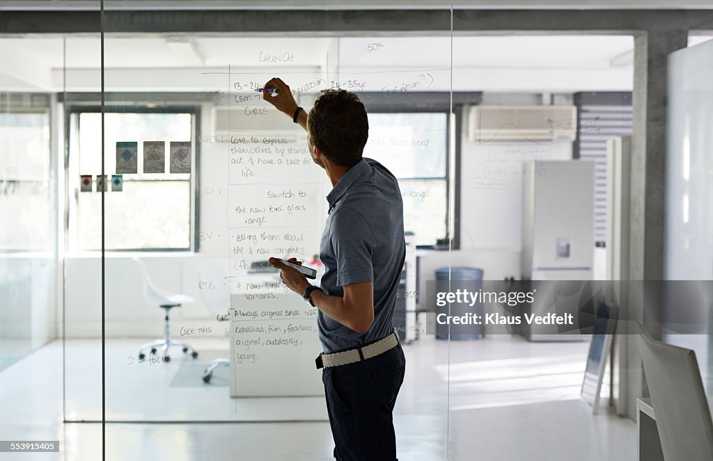 Business writing strategy on glass wall
