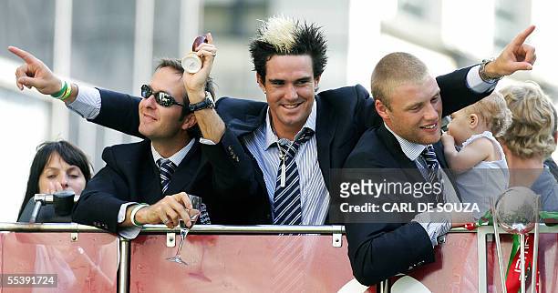 London, UNITED KINGDOM: From left, England cricket captain Michael Vaughn lifts up a replica of the Ashes trophy with Kevin Pietersen and Freddie...