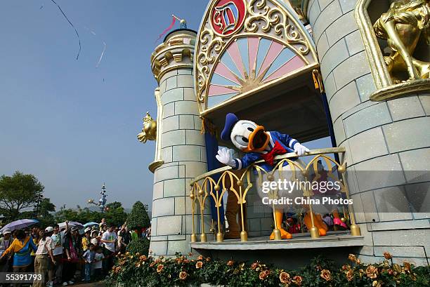 Worker dressed as the Donald Duck welcomes tourists at the Hong Kong Disneyland on September 12, 2005 in Hong Kong, China. Disney officially opened...