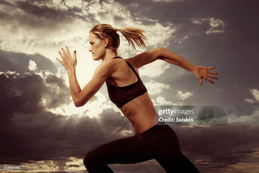 Woman running. Evening sky in the background