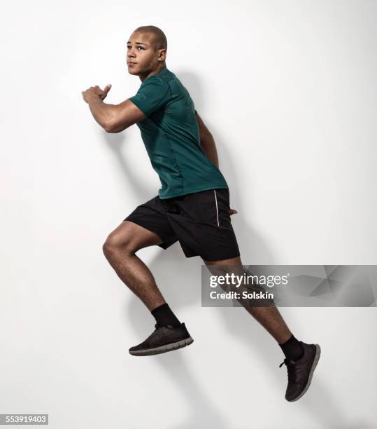 young athlete man jumping - teen boy shorts stock pictures, royalty-free photos & images