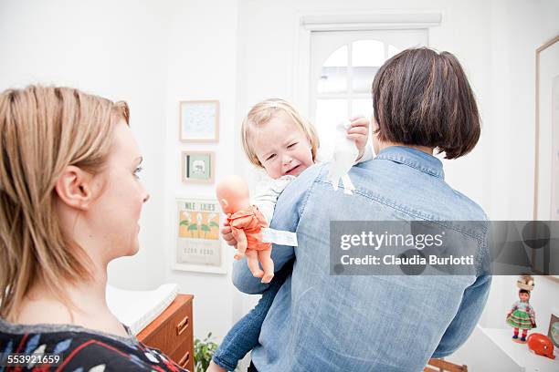 lesbian couple at home with their daughter - distraught child stock pictures, royalty-free photos & images