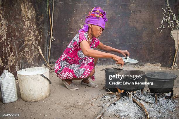 woman cooking in traditional dress - firewood stock pictures, royalty-free photos & images