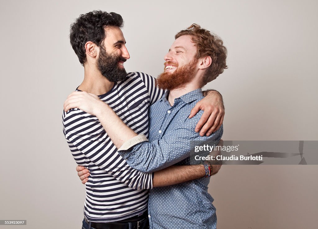 Gay couple hugging and laughing