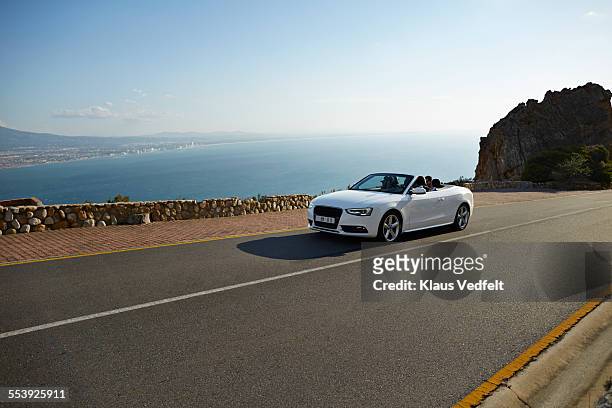friends driving in convertible car on mountainroad - car on road photos et images de collection