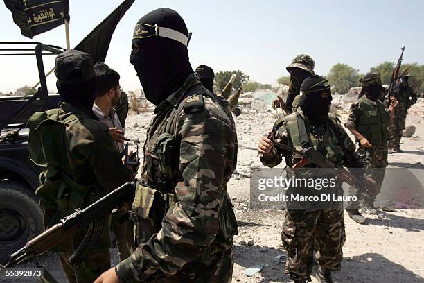 Masked members of the militant group, Islamic Jihad, attend a media conference at the synagogue in the former Jewish settlement of Netzarim September...