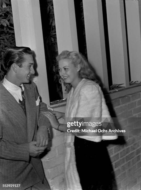 Actress Adele Mara with a friend smile on a street in Los Angeles, California.