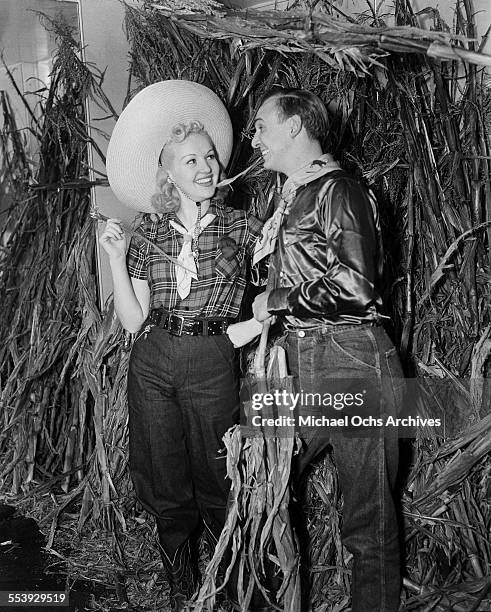 Actress Betty Grable and husband actor Jackie Coogan attend a party in Los Angeles, California.