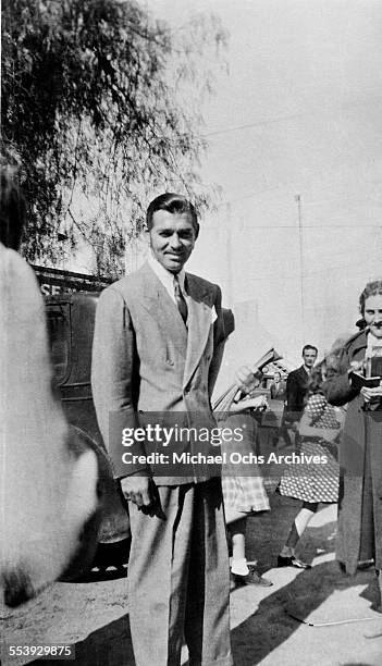 Actor Clark Gable poses on the street in Los Angeles, California.