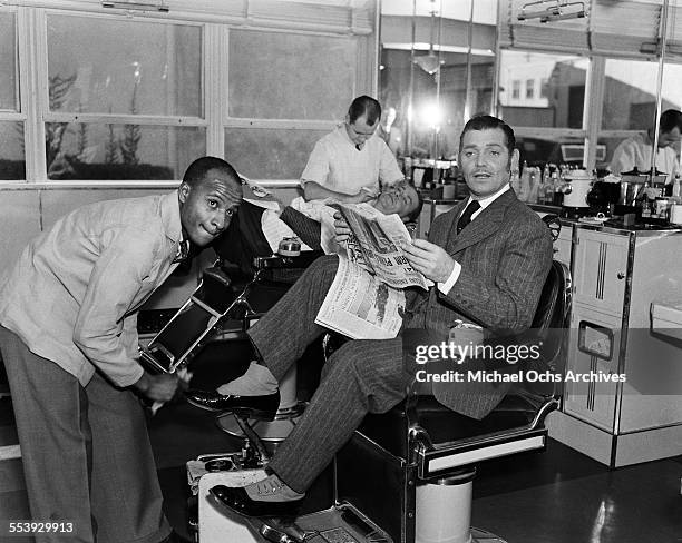 Actor Clark Gable poses in costume for the MGM film 'Parnell' as he gets his shoes shined in Los Angeles, California.