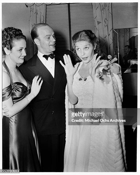 Actress Dorothy Lamour with actor Edgar Bergen laugh at actress Martha Raye during an event in Los Angeles, California.