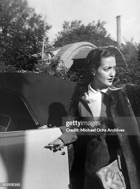 Actress Dorothy Lamour poses as she enters her car on a street in Los Angeles, California.