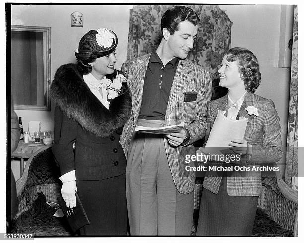 Actress Frances Langford with actor Robert Taylor talk with actress Janet Gaynor in Los Angeles, California.