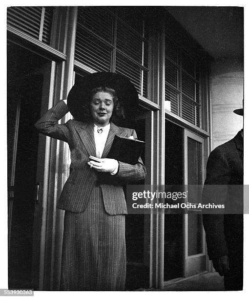 Actress Alice Faye grabs her hat as she leaves work in Los Angeles, California.