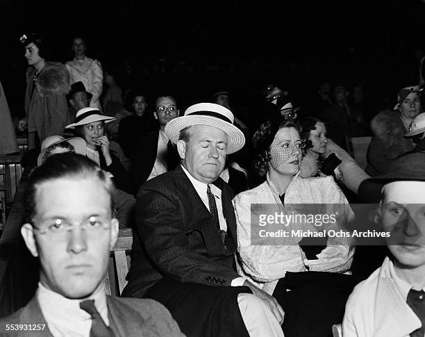 Actress Irene Dunne sits with husband Dentist Francis Dennis Griffin during an event in Los Angeles, California.