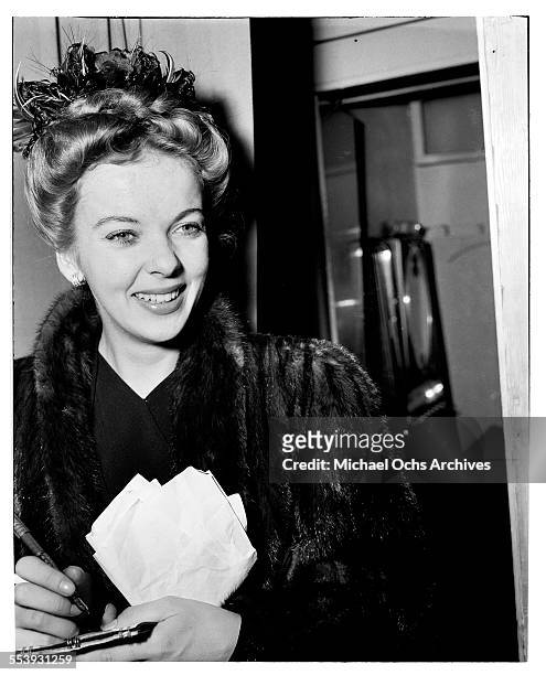 Actress Ida Lupino signs her autograph for fans in Los Angeles, California.