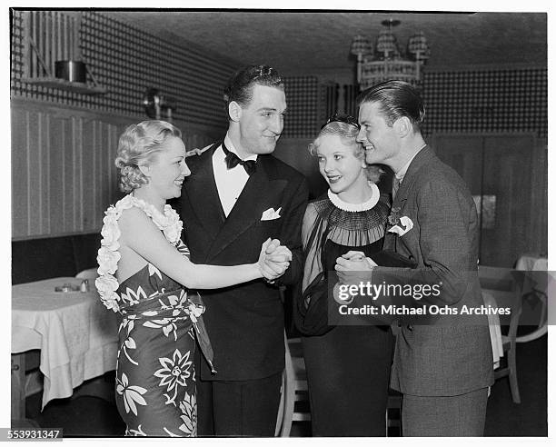 Actress Isabel Jewell dances with actor William Tannen and actress Ida Lupino dances with a friend at Cafe Trocadero in Los Angeles, California.