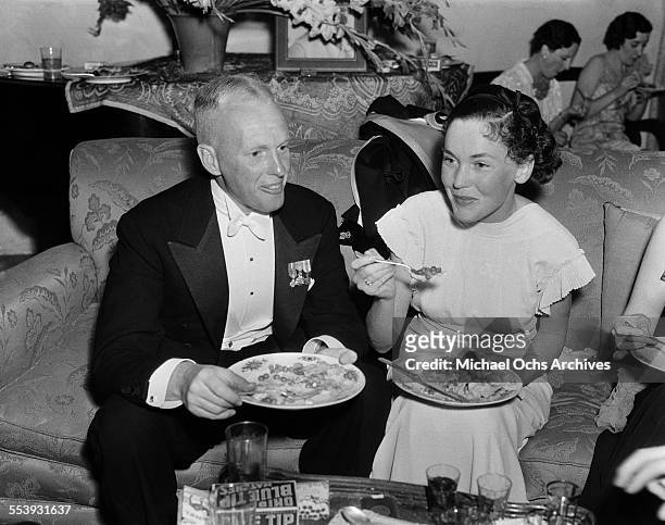 Director John Farrow and wife actress Maureen O'Sullivan attend a party at actor Alan Mowbray home in Los Angeles, California.