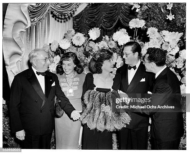 Producer Louis B. Mayer with actress Paulette Goddard, actress Joan Crawford, producer Hunt Stromberg and director George Cukor pose during the...