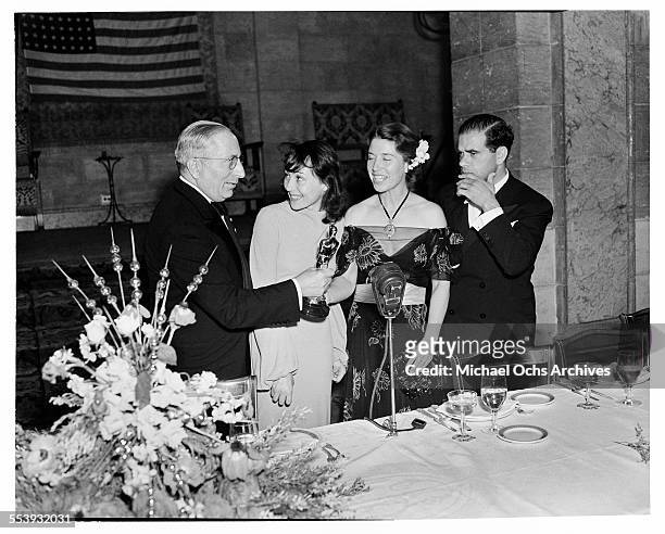 Producer Louis B. Mayer presents the Oscar to actress Luise Rainer for the Academy Award for Best Actress and Mrs Louise Tracy accepting for husband...