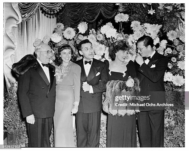 Producer Louis B. Mayer with actress Paulette Goddard, director George Cukor, actress Joan Crawford, producer Hunt Stromberg pose during the premire...