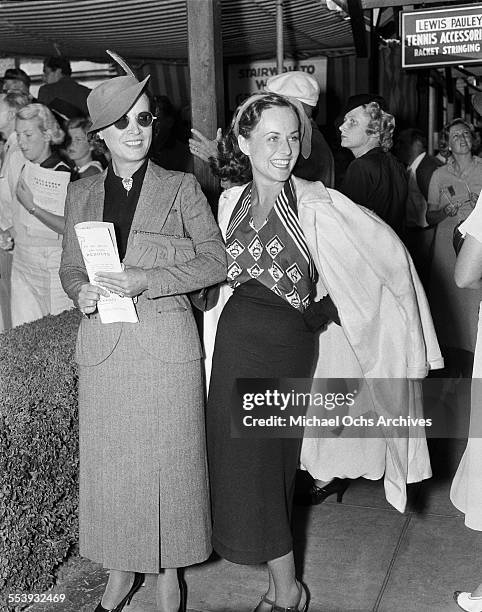 Actresses Paulette Goddard and Mary Astor attend a tennis event Los Angeles, California.